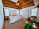 Comfortable primary bedroom with a wood ceiling, plush bed, and decorative accents at 8754 King St, Placida, FL 33946