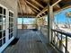 A view from the porch overlooking the beach and ocean with tropical vegetation at 8754 King St, Placida, FL 33946