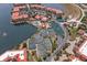 Aerial view showcases community amenities, including tennis courts, pools, and waterways; surrounded by condominiums at 93 Vivante Blvd # 9344, Punta Gorda, FL 33950