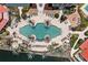 Birds eye view of the freeform swimming pool with mature palms and several lounge chairs, situated near waterfront at 93 Vivante Blvd # 9344, Punta Gorda, FL 33950