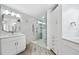 Tiled glass enclosed shower with dual shower heads and seating in a bright modern bathroom at 93 Vivante Blvd # 9344, Punta Gorda, FL 33950