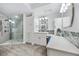 Spacious bathroom featuring double vanity, large storage cabinet, and tiled glass enclosed shower at 93 Vivante Blvd # 9344, Punta Gorda, FL 33950