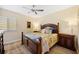 Comfortable bedroom with a ceiling fan, a large bed, and matching wooden dressers at 93 Vivante Blvd # 9344, Punta Gorda, FL 33950