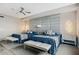 Comfortable bedroom featuring a ceiling fan, two beds, and a decorative upholstered headboard wall at 93 Vivante Blvd # 9344, Punta Gorda, FL 33950