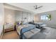 Comfortable bedroom featuring a ceiling fan, two beds, and a decorative upholstered headboard wall at 93 Vivante Blvd # 9344, Punta Gorda, FL 33950