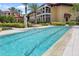 Lap pool with pristine water and manicured landscaping adjacent to condominium with views of other community buildings at 93 Vivante Blvd # 9344, Punta Gorda, FL 33950