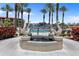 Ornate stone fountain with dolphin statues surrounded by palm trees and well-manicured landscaping near community pool at 93 Vivante Blvd # 9344, Punta Gorda, FL 33950