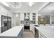 Modern kitchen with stainless steel appliances, an island, and custom backsplash at 93 Vivante Blvd # 9344, Punta Gorda, FL 33950