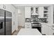Bright kitchen with stainless steel appliances, an island, and custom backsplash at 93 Vivante Blvd # 9344, Punta Gorda, FL 33950