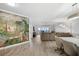 Open floor plan living room featuring a large mural, ceiling fan and plenty of sunlight at 93 Vivante Blvd # 9344, Punta Gorda, FL 33950