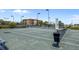 Exterior of a tennis court with manicured landscaping and a building in the background at 93 Vivante Blvd # 9344, Punta Gorda, FL 33950
