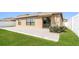 Backyard view featuring a patio, lawn, and privacy fence at 10204 Carloway Hills Dr, Wimauma, FL 33598