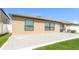 Backyard view featuring a patio, lawn, and exterior wall at 10204 Carloway Hills Dr, Wimauma, FL 33598