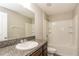 Bright bathroom featuring a granite countertop vanity, a sink, and a shower-tub combination at 10204 Carloway Hills Dr, Wimauma, FL 33598