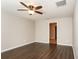 Comfortable bedroom with a ceiling fan and hardwood floors at 10204 Carloway Hills Dr, Wimauma, FL 33598