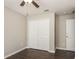 Simple bedroom with hardwood floors, closet, and ceiling fan at 10204 Carloway Hills Dr, Wimauma, FL 33598