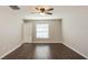 Cozy bedroom with a ceiling fan, hardwood floors, and a bright window at 10204 Carloway Hills Dr, Wimauma, FL 33598