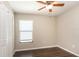 Cozy bedroom with a ceiling fan, hardwood floors, and a window at 10204 Carloway Hills Dr, Wimauma, FL 33598