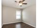 Cozy bedroom features hardwood floors, ceiling fan, and a window at 10204 Carloway Hills Dr, Wimauma, FL 33598