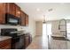 Well-equipped kitchen featuring granite countertops, modern appliances, and a stylish faucet at 10204 Carloway Hills Dr, Wimauma, FL 33598