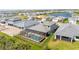 Aerial view of the backyard featuring a screened-in pool with a pool, a fenced yard, and neighborhood at 12857 Pinnacle Ln, Venice, FL 34293