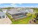 Aerial view of a home featuring a screened-in pool, fenced yard, and a lush green lawn at 12857 Pinnacle Ln, Venice, FL 34293