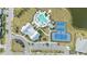 Aerial view of the community pool, tennis courts, clubhouse, and parking area at 12857 Pinnacle Ln, Venice, FL 34293