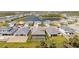 An aerial view of a neighborhood showcasing homes with pools and scenic water views at 12857 Pinnacle Ln, Venice, FL 34293