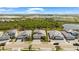 An aerial view of several homes in a neighborhood near a lake and lush greenery at 12857 Pinnacle Ln, Venice, FL 34293
