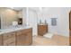 Bright bathroom with dual sinks, granite countertops, and wooden cabinets at 12857 Pinnacle Ln, Venice, FL 34293