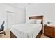 Cozy bedroom features a bed, nightstand, and closet with sliding doors at 12857 Pinnacle Ln, Venice, FL 34293