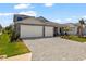 Attractive home with a three-car garage, well-maintained lawn, and tasteful landscaping at 12857 Pinnacle Ln, Venice, FL 34293