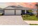 Charming single-Gathering home boasting a brick driveway and a two-car garage, complemented by a well-manicured lawn at 12857 Pinnacle Ln, Venice, FL 34293