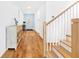 Bright hallway features hardwood floors, stairway, and decorative console table at 12857 Pinnacle Ln, Venice, FL 34293