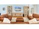 Cozy living room featuring hardwood floors, modern furniture, and a large screen TV at 12857 Pinnacle Ln, Venice, FL 34293