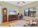 Comfortable living room features hardwood floors, a large window, and a workspace at 12857 Pinnacle Ln, Venice, FL 34293