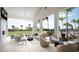 Covered patio with comfortable seating, ceiling fan, and view of the expansive lawn and surrounding community at 12857 Pinnacle Ln, Venice, FL 34293