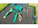 Aerial view of a vibrant playground featuring slides, climbing structures, and a safety-surface ground at 12857 Pinnacle Ln, Venice, FL 34293