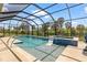 An inviting screened-in pool with lounge chair and a scenic backyard view at 12857 Pinnacle Ln, Venice, FL 34293