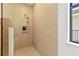 Modern shower featuring a rainfall showerhead and a built-in niche for toiletries at 12857 Pinnacle Ln, Venice, FL 34293