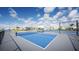 Bright blue tennis courts with a black fence on a sunny day, perfect for active community members at 12857 Pinnacle Ln, Venice, FL 34293