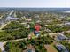 Aerial view of the home's location within a residential neighborhood surrounded by lush greenery and waterways at 13443 Boabadilla Ln, Port Charlotte, FL 33981