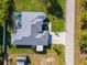 Aerial view of a home with a pool, patio and lush green lawn at 13443 Boabadilla Ln, Port Charlotte, FL 33981