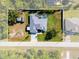 Aerial view showcases the expansive property with a house, pool, and outbuildings at 13443 Boabadilla Ln, Port Charlotte, FL 33981