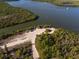 Aerial view of a boat launch area with cars, trucks and SUV's parked near the edge of the water at 13443 Boabadilla Ln, Port Charlotte, FL 33981