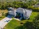 Aerial view of a well-manicured home and lawn with palm trees at 13443 Boabadilla Ln, Port Charlotte, FL 33981