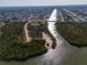 Wide aerial view of a waterway with residential development on the opposite bank and scrub forest at 13443 Boabadilla Ln, Port Charlotte, FL 33981