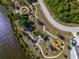Aerial view of a park with winding sidewalks, landscaping, water feature and roadside parking at 13443 Boabadilla Ln, Port Charlotte, FL 33981