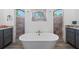 Bathroom features a freestanding tub and dual vanities with granite countertops at 13443 Boabadilla Ln, Port Charlotte, FL 33981