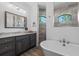 Bathroom showcases a luxurious freestanding tub, separate shower, and dual sinks at 13443 Boabadilla Ln, Port Charlotte, FL 33981